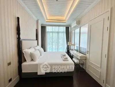 Luxurious bedroom with elegant decor and large windows offering natural light.