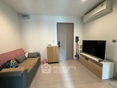 Modern living room with sleek furniture and air conditioning, perfect for cozy urban living.