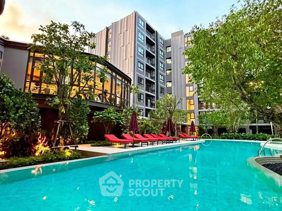 Luxurious condominium with stunning pool and lush garden view, perfect for relaxation and modern living.
