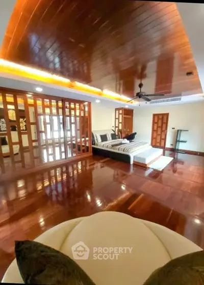 Luxurious bedroom with wooden flooring and modern design elements, perfect for a serene retreat.