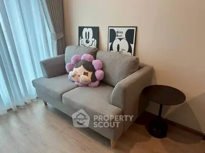 Cozy living room with stylish sofa and playful decor, perfect for relaxation and entertainment.