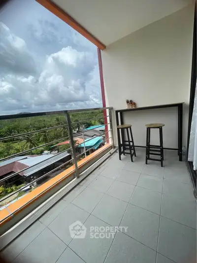 Spacious balcony with scenic view, perfect for relaxation and enjoying the outdoors.