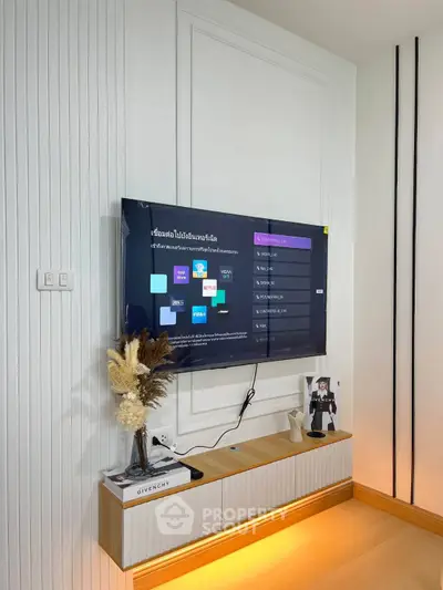 Modern living room with wall-mounted TV and stylish decor