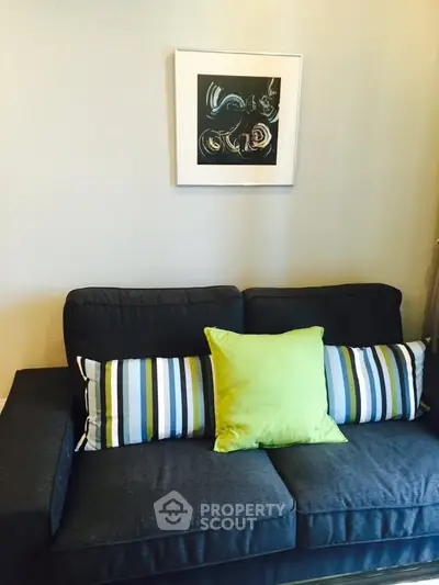 Cozy living room with stylish sofa and modern wall art, perfect for relaxation and entertaining guests.