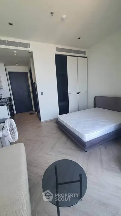 Modern studio apartment with minimalist design and cozy furnishings.