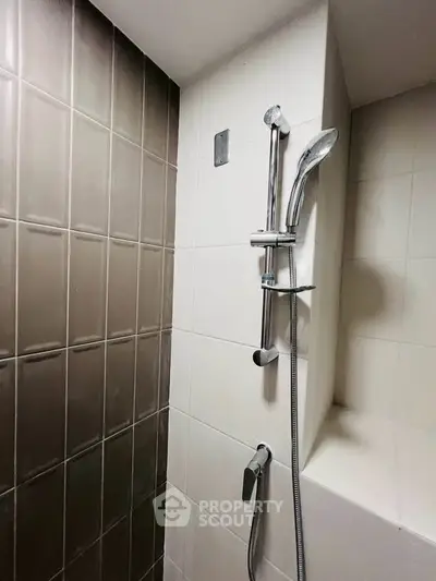 Modern bathroom shower with sleek tile design and chrome fixtures