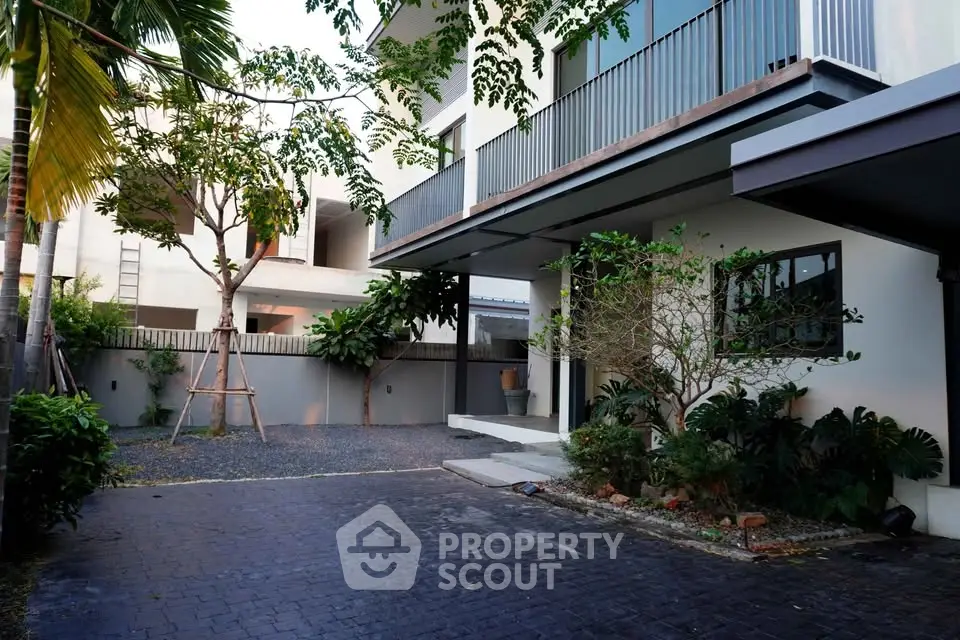 Modern house exterior with lush garden and spacious driveway