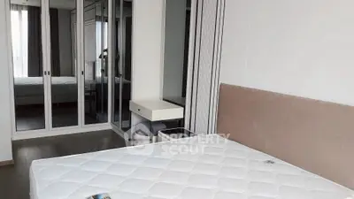 Spacious bedroom with mirrored wardrobe and modern furnishings