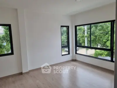 Spacious corner unit with large windows and natural light in modern apartment.