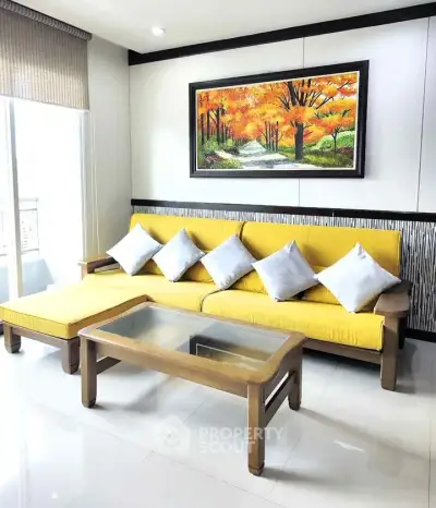 Bright living room with yellow sofa and autumn landscape painting, perfect for modern home decor.