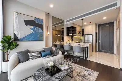 Modern open-plan living room with stylish kitchen and contemporary decor.