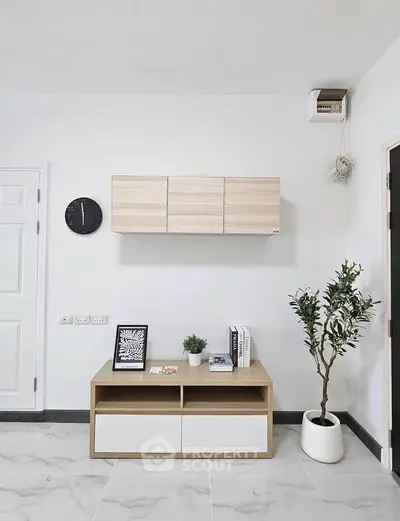 Modern minimalist living room with sleek furniture and decorative plant