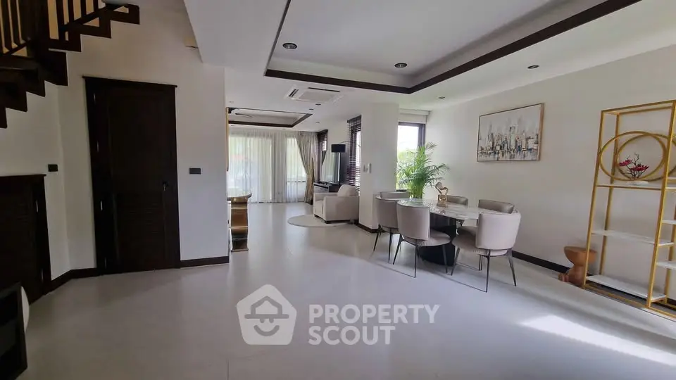 Spacious modern living room with elegant dining area and natural light