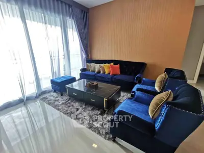 Luxurious living room with plush blue velvet sofa and elegant decor