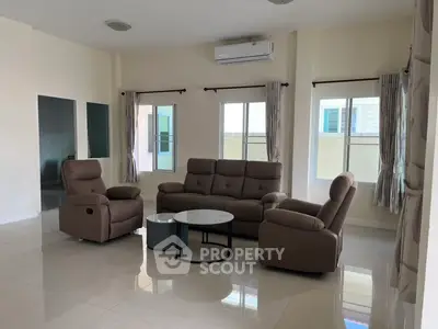 Spacious living room with modern furniture and large windows for natural light.