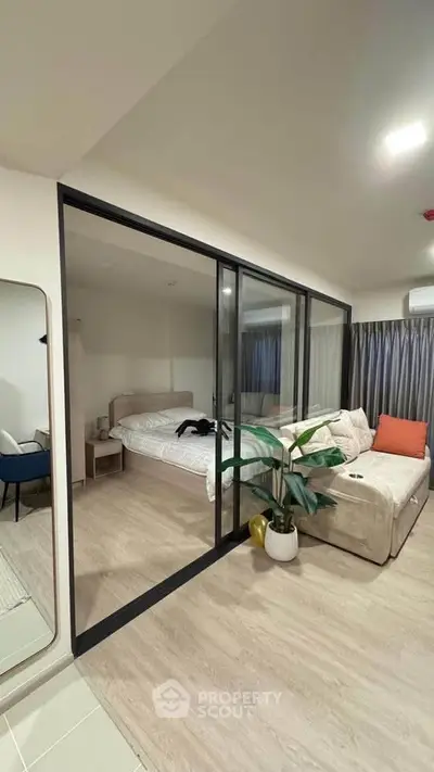 Modern bedroom with glass partition and cozy decor in stylish apartment
