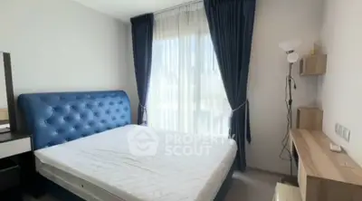 Spacious bedroom with elegant blue headboard and natural light