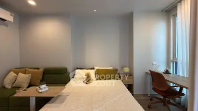 Cozy bedroom with modern decor, featuring a comfortable bed, stylish sofa, and a functional study desk by the window.