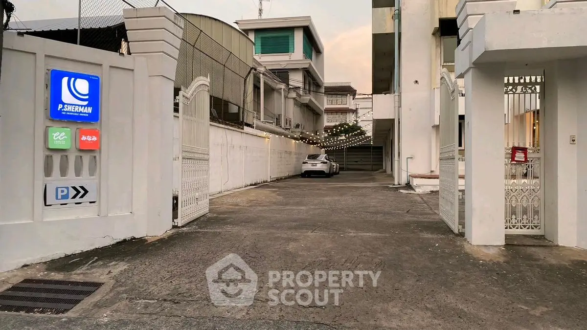 Charming gated entrance with ample parking space in a serene residential area.