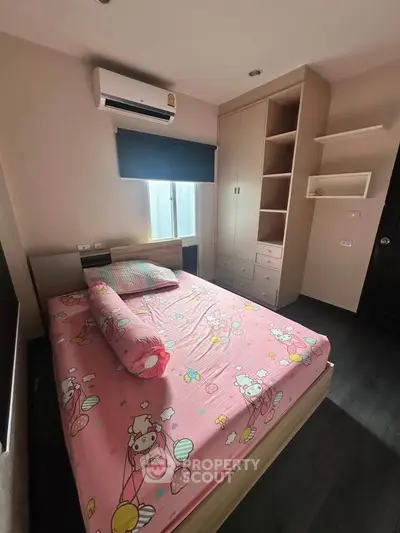Charming bedroom with playful pink bedding and ample storage, perfect for a cozy retreat.