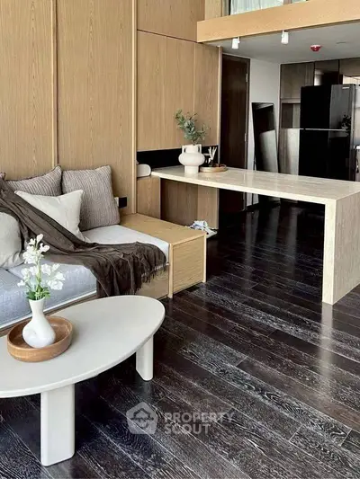 Modern living room with sleek wooden flooring and stylish decor