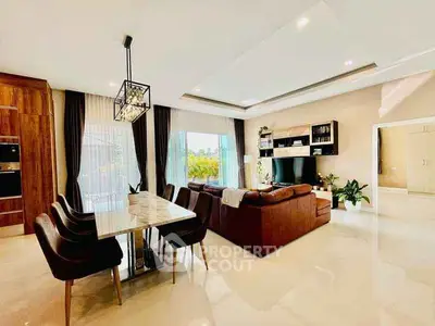 Luxurious open-plan living room with elegant dining area and modern decor.