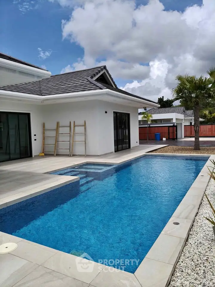 Luxurious modern home with a stunning private pool and elegant exterior design, perfect for relaxation and entertainment.