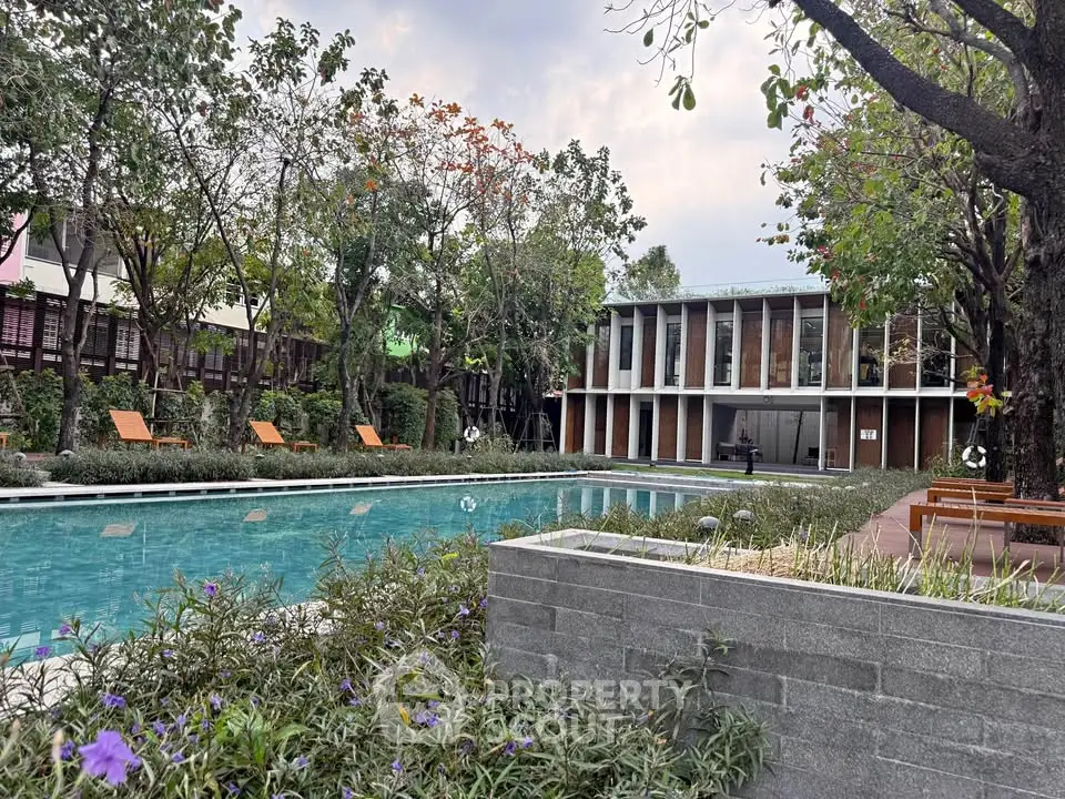 Luxurious residential pool area with modern architecture and lush greenery