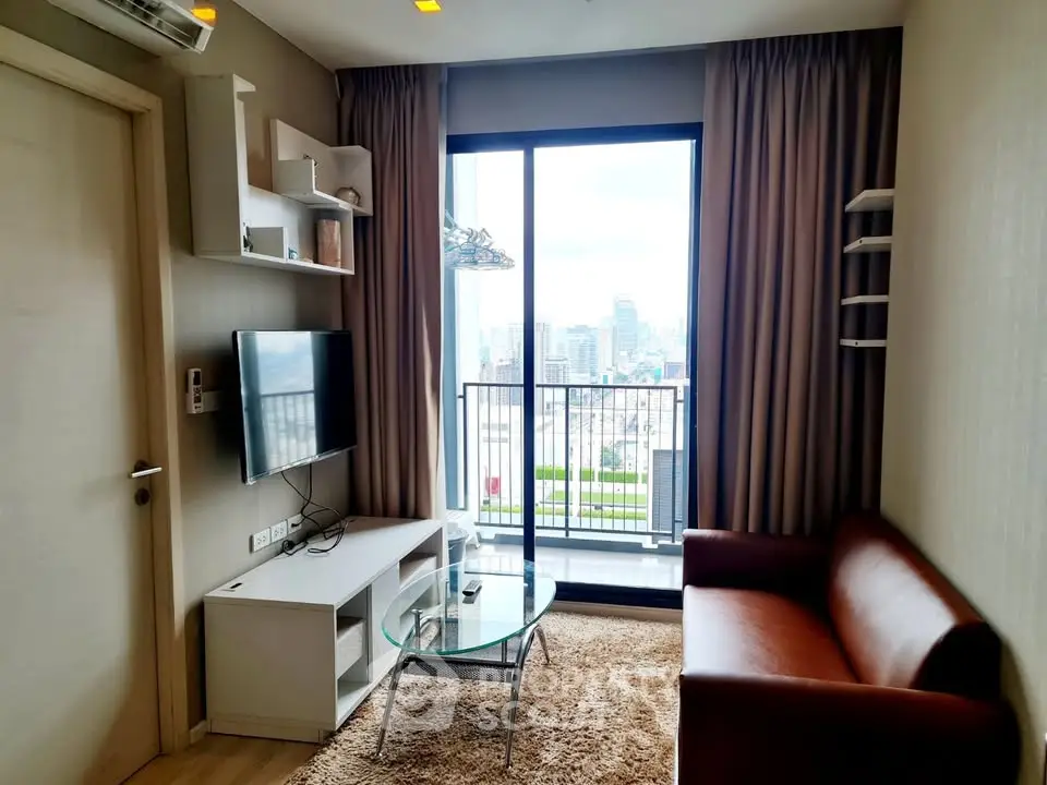 Modern living room with city view balcony, sleek furniture, and wall-mounted TV in a stylish apartment.