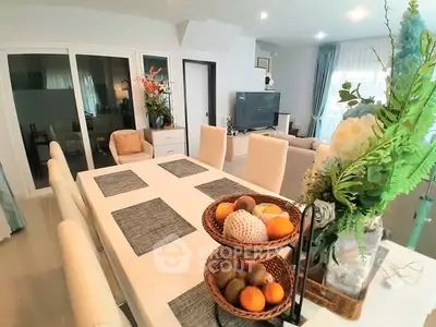 Elegant dining area with modern decor and spacious living room view, perfect for family gatherings.