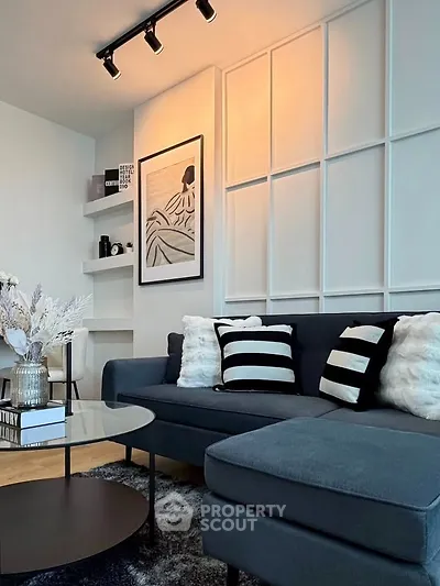 Modern living room with stylish decor, featuring a cozy sectional sofa and elegant wall art.