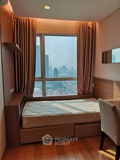 Cozy bedroom with city view, featuring a single bed and elegant wooden decor, perfect for urban living.
