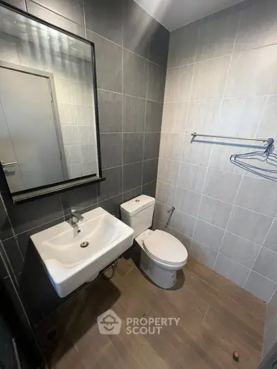Modern bathroom with sleek fixtures and stylish tile design, perfect for contemporary living.
