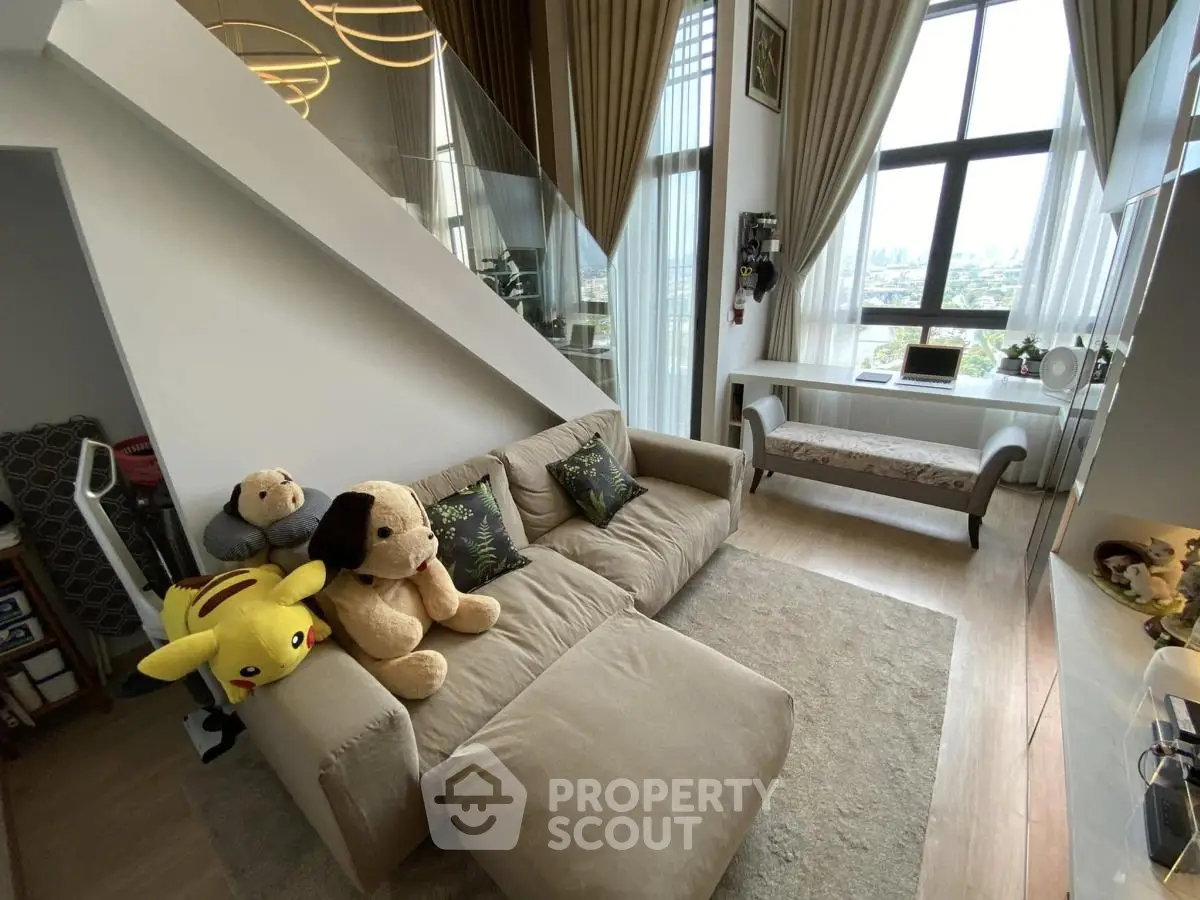 Modern living room with plush toys and large windows offering city views
