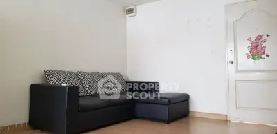 Cozy living room with black sectional sofa and minimalist decor