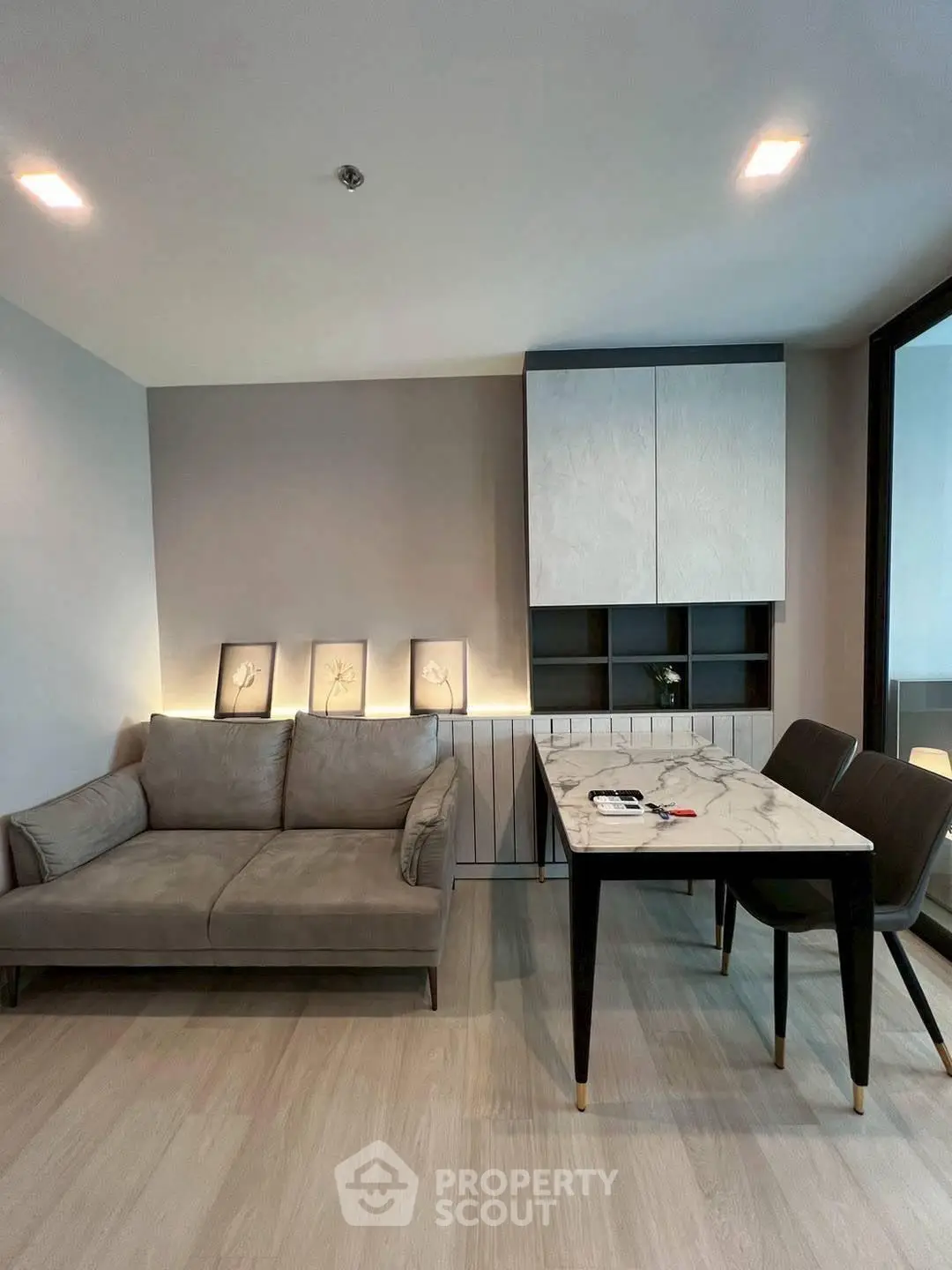 Modern living room with stylish sofa and dining table in contemporary apartment