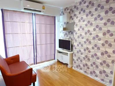 Charming living room with stylish wallpaper and cozy seating, perfect for relaxation.