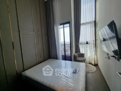 Modern bedroom with high ceilings and balcony view in luxury apartment