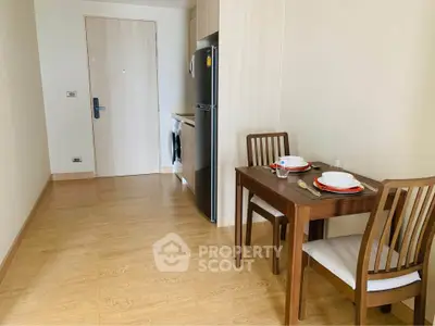Cozy dining area with wooden table and chairs in modern apartment