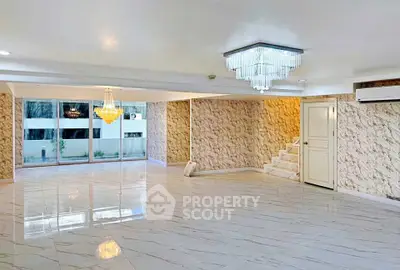 Spacious modern living room with elegant chandeliers and marble flooring
