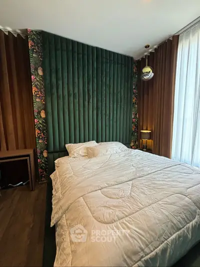 Luxurious bedroom with plush green velvet accent wall and elegant decor