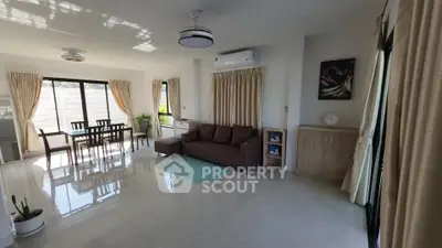 Spacious living room with modern furniture and large windows offering natural light.