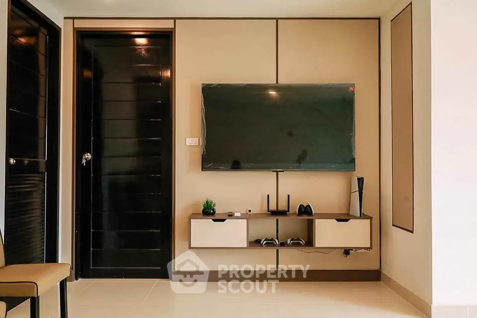 Modern living room with wall-mounted TV and sleek storage solutions