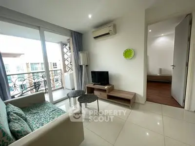 Modern living room with balcony access and stylish furniture in a bright apartment.