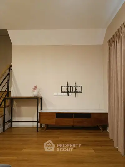 Modern living room with wooden flooring and TV mount