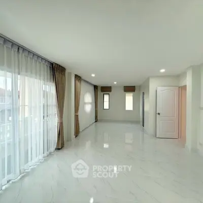 Spacious and bright living room with elegant curtains and glossy tile flooring