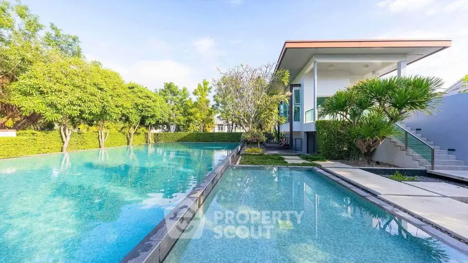 Luxurious modern villa with stunning pool and lush greenery, perfect for serene living.
