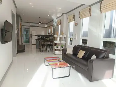 Spacious modern living room with sleek furniture and abundant natural light