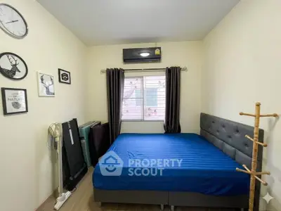 Cozy bedroom with modern decor and natural light, featuring a comfortable bed and stylish wall art.