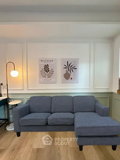 Stylish living room with modern gray sectional sofa and elegant wall art, perfect for contemporary homes.
